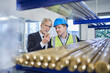 © Westend61 - Manager discussing over metallic bolt with supervisor in factory