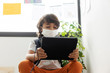 © Westend61 - Boy wearing face mask using digital tablet while sitting in school