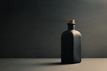 Single Black Ceramic Bottle Over A Dark Background
