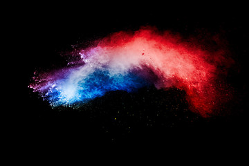 Wall Mural - Red blue dust particles explosioon on black background.Red blue powder splash.