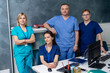© Vadim - Medical team posing over medical office background. Professional doctors at work.