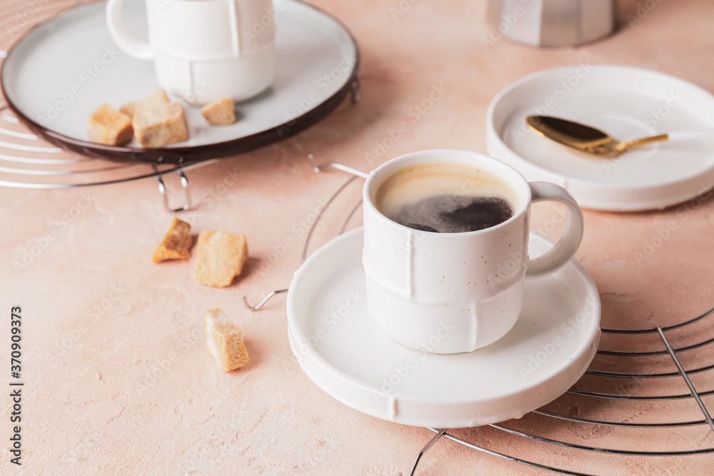 Cup of hot coffee on color background