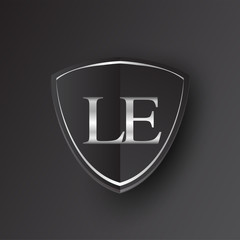 Initial logo letter LE with shield Icon silver color isolated on black background, logotype design for company identity.