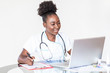 © Graphicroyalty - African American Doctor working in hospital writing a prescription, Healthcare and medical concept,test results in background, Stethoscope with clipboard and Laptop on desk