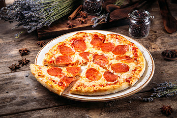 Wall Mural - Sliced pepperoni pizza with salami 