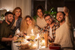 © Syda Productions - holidays, celebration and people concept - happy friends taking selfie by smartphone at home christmas dinner party