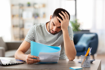 Canvas Print - remote job and business concept - stressed man with papers and laptop computer working at home office