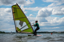 Woman Participating In A Windsurfing Course