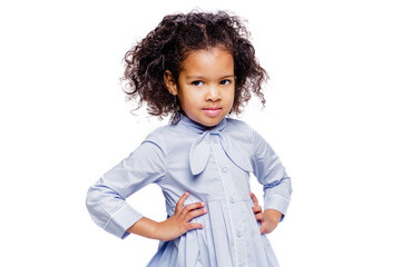 Wall Mural - Portrait of a cute little african american girl in a blue dress, isolated on white background