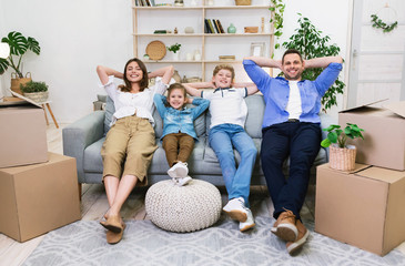 Wall Mural - Happy Family Relaxing After Moving New Apartment Sitting At Home