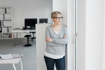 relaxed businesswoman waiting beside the door