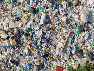 Illegal storage of solid household waste, plastic bottles and garbage bags. Land pollution Aerial top view