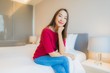 © siraphol - Portrait beautiful young asian woman smile relax on bed