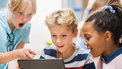 Poster - Elementary School Computer Science Class: Two Girls and Boy Use Digital Tablet Computer with Augmented Reality Software, They’re Excited, Full of Wonder, Curiosity. Children in STEM, Playing, Learning