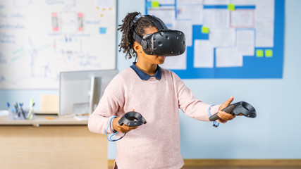 Fototapete - Elementary School Computer Science Class: Cute Girl Wearing Augmented Reality Headset and Using Controllers Learns Lessons in Virtual Reality Excited, Curious and Interested in Knowledge