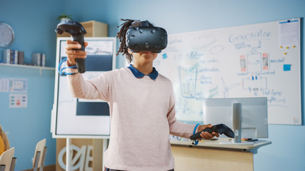 Fototapete - Elementary School Computer Science Class: Cute Girl Wearing Augmented Reality Headset and Using Controllers Learns Lessons in Virtual Reality Excited, Curious and Interested in Knowledge