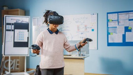 Fototapete - Elementary School Computer Science Class: Cute Girl Wearing Augmented Reality Headset and Using Controllers Learns Lessons in Virtual Reality Excited, Curious and Interested in Knowledge
