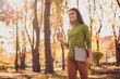 © deagreez - Photo of pretty lovely lady walk hold laptop drink coffee smiling see friend another corner autumn park heading towards unexpected meeting wear green turtleneck orange pants outdoors