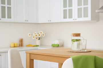 Wall Mural - Stylish wooden table in beautiful kitchen interior