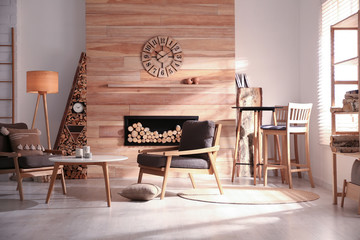 Poster - Decorative fireplace with stacked wood in cozy living room interior