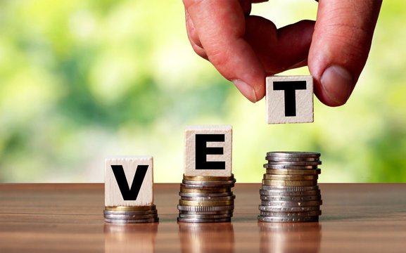 VET word symbol - business concept. Hands put wooden block
