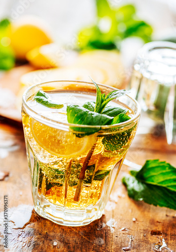 Fototapeta na drzwi i meble Closeup of mojito drink glass and ingredients on vintage wooden table.