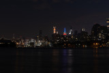 Fototapeta  - Dark Nighttime Roosevelt Island and Manhattan Skyline along the East River in New York City