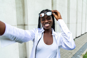 Wall Mural - African american woman taking a selfie outdoors