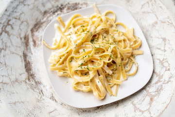 Alfredo pasta dinner with creamy white sauce and herbs