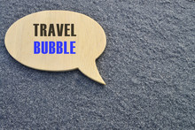Travel Bubble Concept.Black Speech Bubble With Text TRAVEL BUBBLE On Dark Concrete Cement Floor Background.