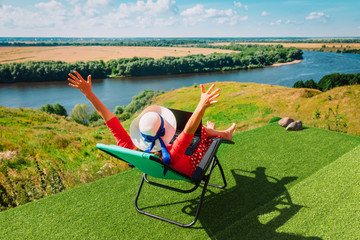 Wall Mural - remote work - young woman working with laptop in the country