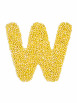 Letter W of the English alphabet made from millet on an isolated background.