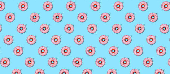 Wall Mural - Seamless pattern with Christmas tree toy donut on blue. Holiday season concept, place for text