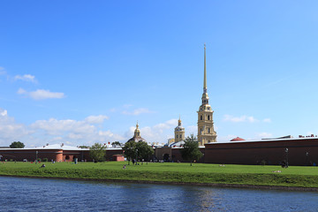 Saint Petersburg, Russia, July 8, 2020, Peter and Paul fortress .. In the photo, the Peter and Paul fortress in close-up on the Bank of the Neva river and tourists walking along the shore