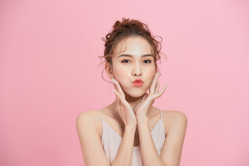beautiful young woman with clean fresh skin touch own face . facial treatment . cosmetology, beauty 