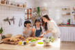 © Koto Amatsukami - Happy and cute Asian family making food in kitchen at home together