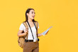 © Atstock Productions - Travel concept portrait of young backpacker Asian woman tourist holding map while looking away in isolated studio yellow background