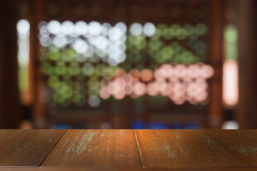 Empty dark wooden table in front of abstract blurred bokeh background of restaurant . can be used for display or montage your products.Mock up for space.