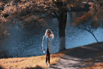 Wall Mural - walk in autumn park / beautiful girl in autumn park, model female happiness and fun in yellow trees  October