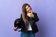 © luismolinero - Young slovak woman holding a motorcycle helmet isolated on purple background with thumbs up because something good has happened