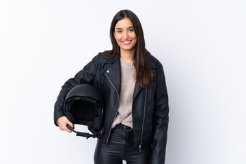 Wall Mural - Young brunette woman with a motorcycle helmet over isolated white background smiling a lot