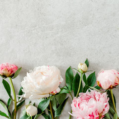 Poster - Beautiful pink peony flowers on gray stone table with copy space for your text. Flat style, top view