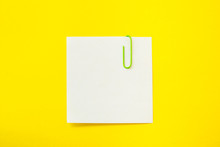 Note Sheet With Paper Clip On Yellow Background