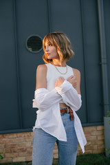 Wall Mural - Young beautiful woman wearing fashionable stylish clothes in front of grey monochrome wall.