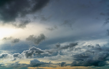 Wall Mural - sunset sky and gray and golden clouds. gray sky and fluffy clouds. thunder and storm sky. sad and mo