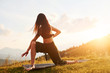 © standret - Doing yoga outdoors. Beautiful woman. Majestic Carpathian Mountains. Beautiful landscape of untouched nature