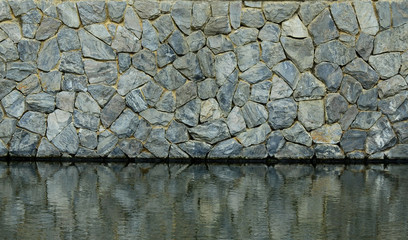 Poster - old stone wall with water reflection in the pond