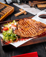 Wall Mural - Closeup on grilled juicy steak with salad