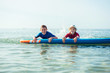 © spass - Two happy siblings teen children in neoprene suits having fun  with sup board in Baltic sea