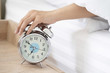 © charnsitr - A Man Hand Try to Stop the Alarm of the Clock in the Morning